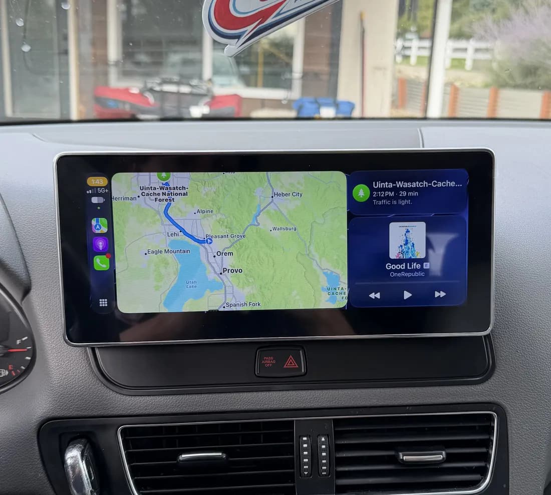 Same 2011 Audi Q5 dashboard after installation, with a larger Apple CarPlay screen
